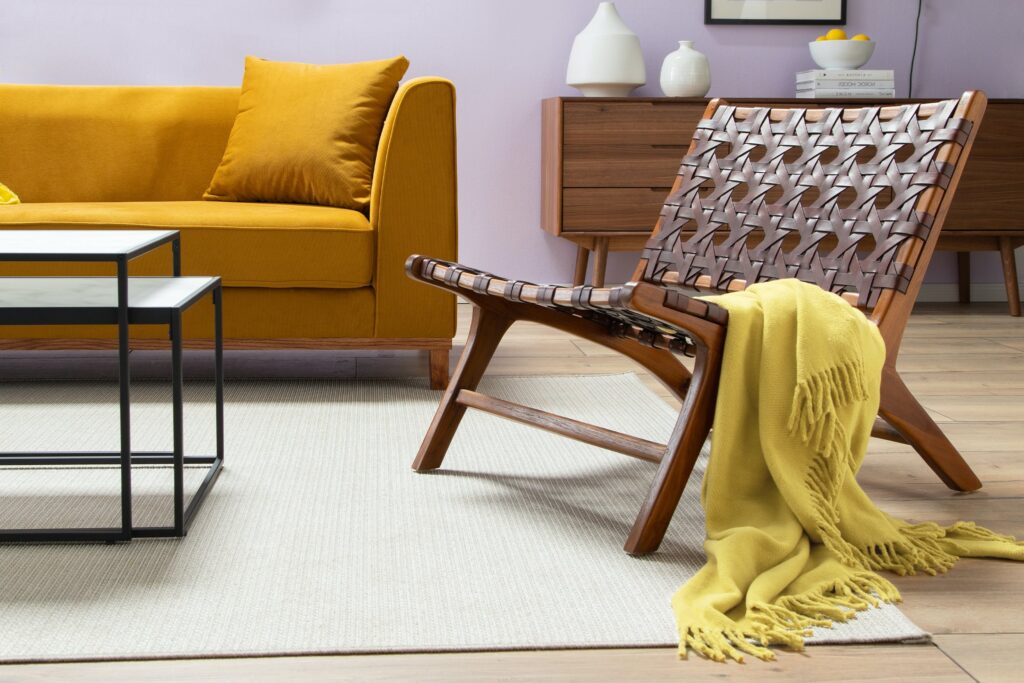 A modern living space featuring a vintage armchair, signifying a deliberate break in style.